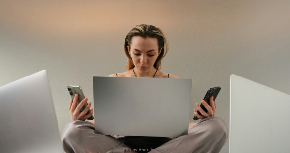Business professional working across a laptop and smartphone
