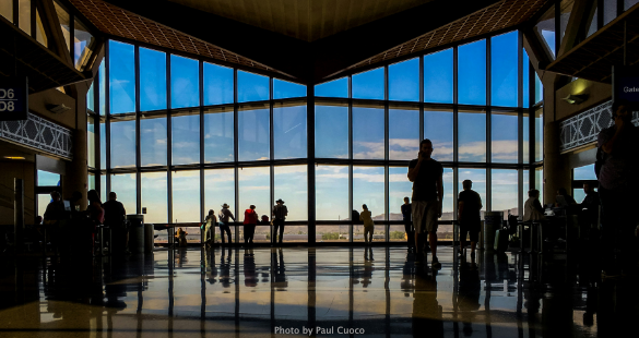 Passengers moving through a functioning modern airport terminal